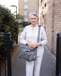 Alice Brown stands in front of a block of flats