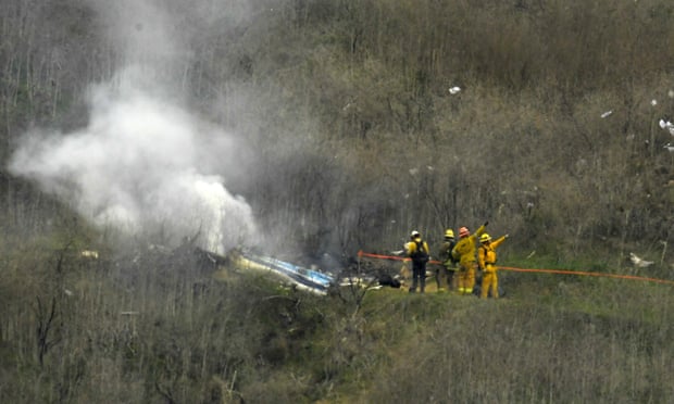 Firefighters work the scene of a helicopter crash that killed Kobe and his 13-year-old daughter.