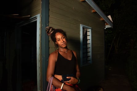 Josie Ralulu leaning against the edge of a building