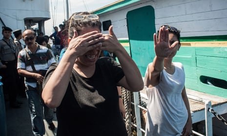 Asylum seekers cover their faces as they leave a boat in Bali, Indonesia, in 2013.