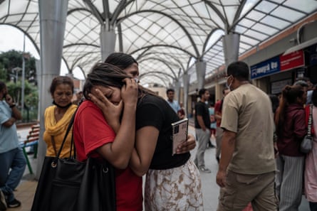 Two women hold each other at the hospital in Kathmandu