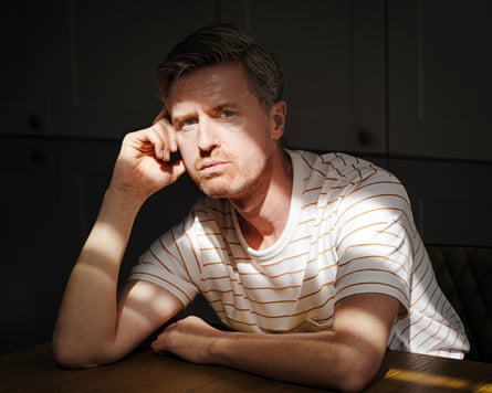 Justin Myers in shadow, his head leaning against his right hand