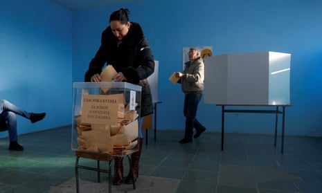 A Kosovo ethnic Serb woman casts her vote at a polling station in the town of Raca, Serbia
