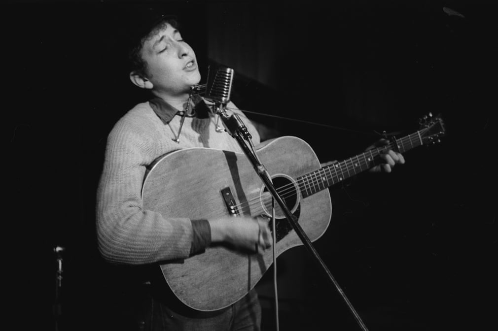 Dylan performs onstage that same night (Note: at Gerde’s Folk City). Photograph Copyright: Ted Russell