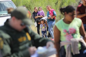 US border patrol agents take people into custody near the border.