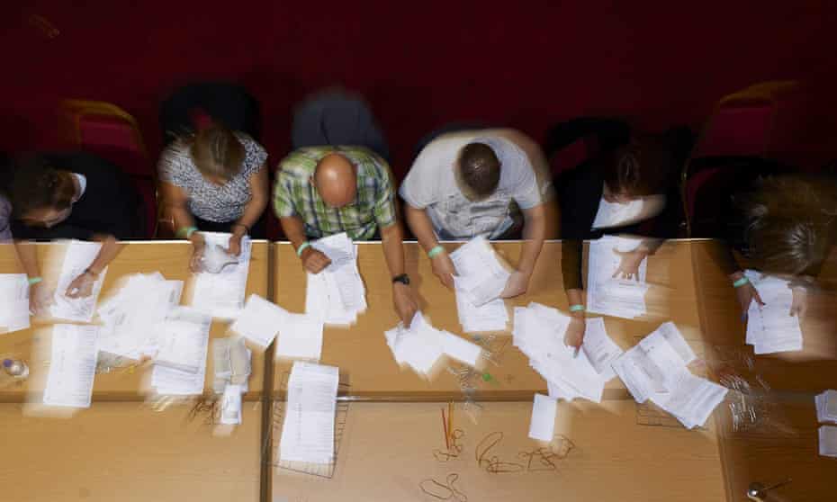 Counting staff sort ballot papers at a vote counting centre in Margate, Kent