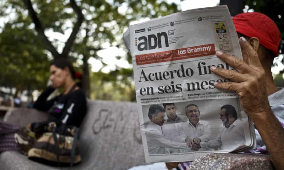 A man in Cali, Colombia, reads a newspaper with a front-page headline reading ‘Final agreement in six months’ following the deal between the government and Farc rebels in Cuba.