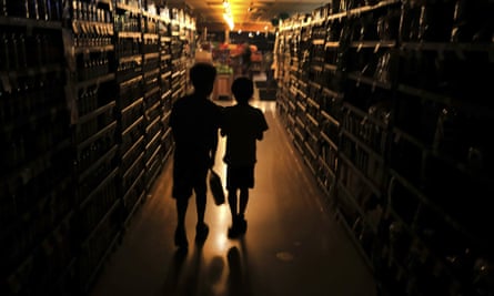 Elijah Carter 11, left, and Robert Haralson, 12, shop in a darkened supermarket in Santa Rosa, California, during a blackout.