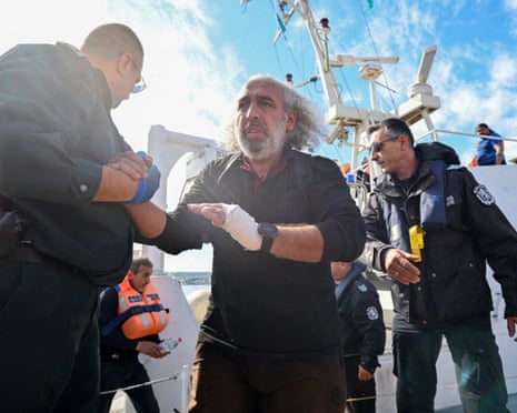 Crew members from a ship damaged in a drone attack disembark from a Bulgarian border police vessel in Varna, Bulgaria.