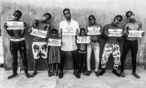 Children hold signs outside Sari market in Orile-Iganmu, Lagos state