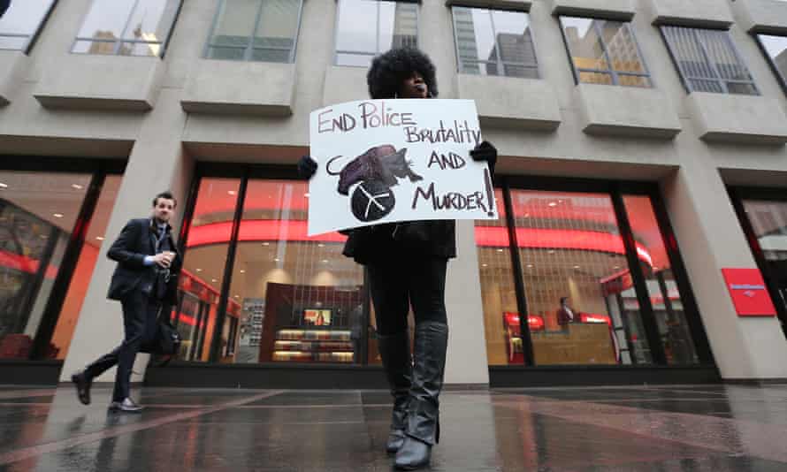 Kadijah Amen-Rah takes part in the counter-protest on a mostly empty sidewalk in front of the NFL’s headquarters.