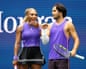 Serena Williams and Carlos Alcaraz smile on stage after their mixed doubles win