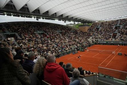 Jack Draper serves against Mattia Bellucci under the roof on Court Suzanne Lenglen.