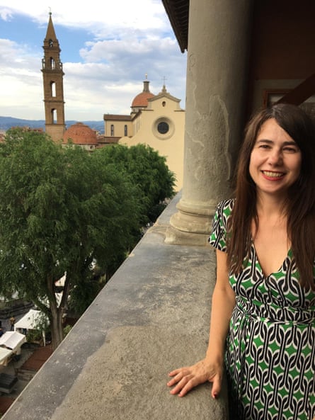 Sabrina Crawford standing on a balcony with a church in the background