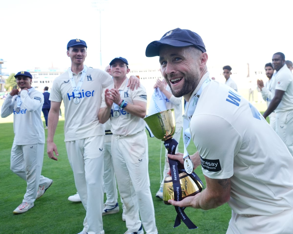 Chris Woakes with the trophy as Warwickshire are crowned county champions