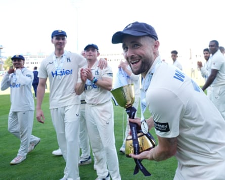 Chris Woakes with the trophy as Warwickshire are crowned county champions