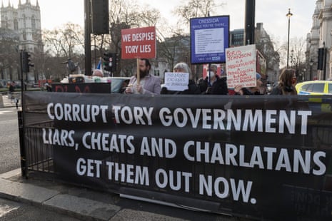 Anti-Johnson campaigners outside the Houses of Parliament today.