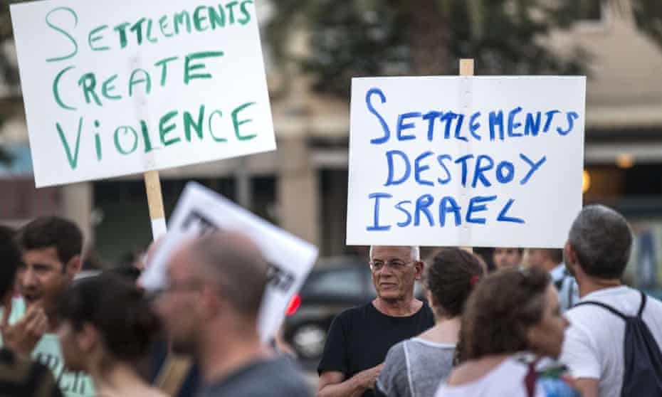 Israelis hold placards during a demonstration in Tel Aviv against the death of 18-month-old Ali Dawabsheh, the toddler who was burned to death by suspected Jewish extremists.