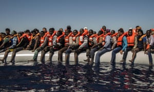 Refugees from Eritrea and other countries wait to be rescued from the Mediterranean Sea, north of Libya.