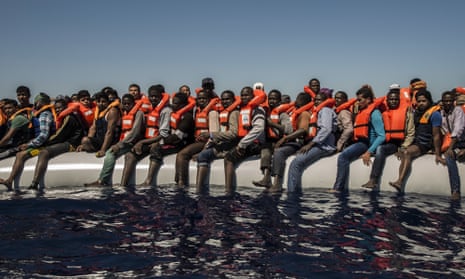 Refugees from Eritrea and other countries wait to be rescued from the Mediterranean Sea, north of Libya. 