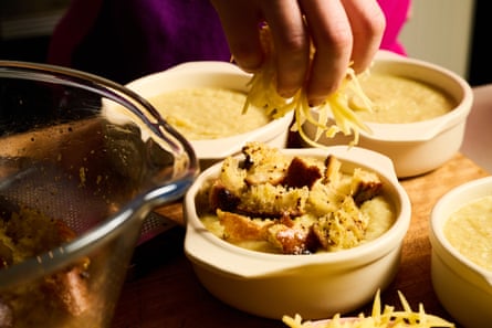 Topping bowls of the soup with cheesy mustardy croutons before they are put under the grill to gratinate