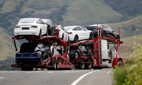 A car carrier hauler bearing electric vehicles departs Tesla’s vehicle factory in Fremont, California, last year.