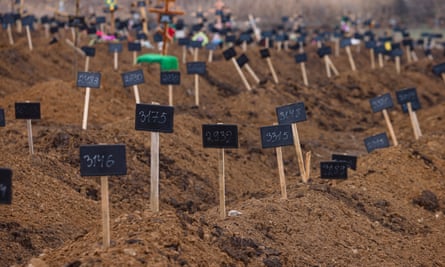 Numbers mark the graves of unidentified residents of Mariupol at the Starokrymske cemetery.