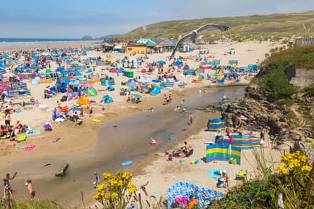 Holidaymakers enjoy warm weather at Perranporth Beach in summer 2020.