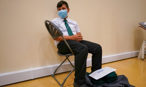 Felix Dima, 13, receives the Pfizer vaccine at the Excelsior academy in Newcastle upon Tyne.