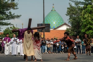 People in costume, one carrying a cross