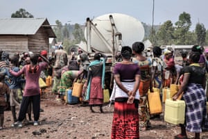 People gather to fill containers from a water truck in Kanyaruchinya on the outskirts of Goma, the capital of eastern DRC’s North Kivu province, in 2017. Many neighbourhoods do not have access to running water and rely instead on communal pumps or water trucks.