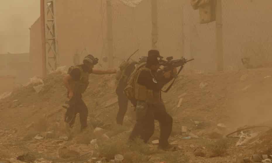 In this 14 May 2015 file photo, security forces defend their headquarters against attacks by Isis during a sand storm in the eastern part of Ramadi. The city fell to Isis forces three days later.