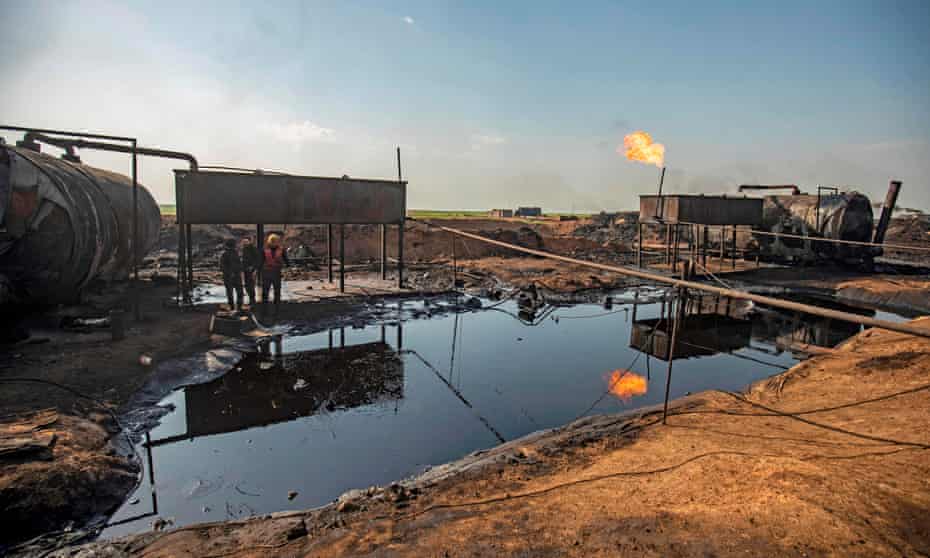 Men work at a primitive oil refinery in the countryside of al-Qahtaniyah town, in Syria’s north-eastern Hasakeh province