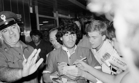 Diego Maradona thronged by fans after landing at Rome airport in July 1984, the month he signed for Napoli.