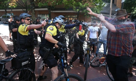 Police use pepper spray as multiple groups including Rose City Antifa and the Proud Boys in downtown Portland, Oregon.