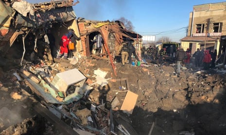 Rescuers look through the rubble in the aftermath of an attack on a local market in Shevchenkove village, Kharkiv region, amid Russia’s invasion of Ukraine, in this image released January 9, 2023.