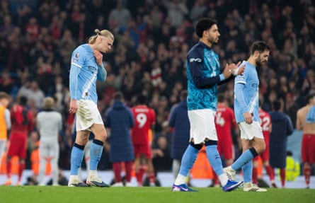 Erling Haaland (left) and his teammates trudge off the pitch at full time