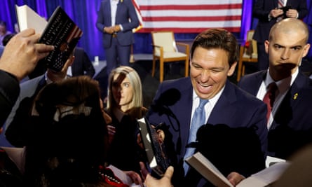The Florida governor, Ron DeSantis, signs books after his remarks in Des Moines, Iowa, on Friday. Most leading Republicans ‘want DeSantis to be the guy’, former congressman Joe Walsh said.