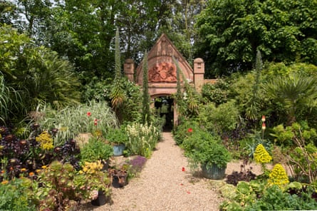 Gate entrance surrounded by beds of exotic tropical plants at East Ruston.