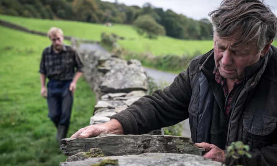 Farmers Raymond and Adam repair a wall in Cumbria