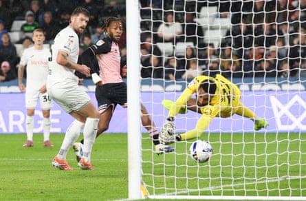 QPR’s Rumarn Burrell (second right) makes it 1-0 against Swansea