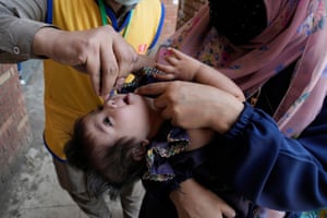 Lahore, Pakistan. A health worker administers a vaccine to a child as the country launches an anti-polio campaign targeting millions of under-fives. It is one of two countries in the world where polio continues to threaten the health and wellbeing of children