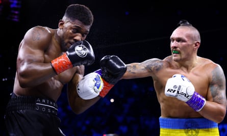 Oleksandr Usyk punches Anthony Joshua during their fight in Jeddah.