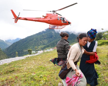 A Nepali police helicopter carrying relief supplies lands in Rasuwa district