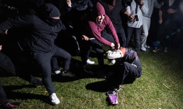 A pro-Palestinian demonstrator is beaten by counter-protesters attacking a pro-Palestinian encampment on the campus of the University of California Los Angeles.