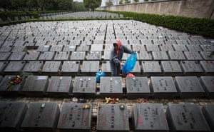 Shanghai, China A worker cleans the graves during the annual Qingming festival, or Tomb Sweeping Day, at a public cemetery. Chinese traditionally tend the graves of their departed loved ones and often burn paper money, model houses, cars, mobile phones and other goods as offerings to honour them and keep them comfortable in the afterlife