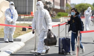 A student wearing a face mask arrives at Changchun University of Chinese Medicine as it reopens on Friday