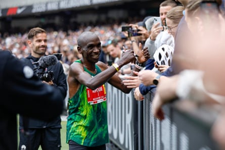 Kipchoge celebrates with fans at the MCG