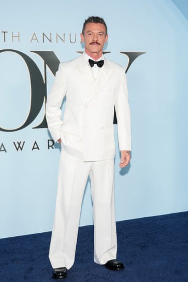 Luke Evans in a white tux with a black bowtie