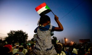 A Sudanese child waves a national flag as she sits atop the shoulders of a man during a late demonstration demanding a civilian body to lead the transition to democracy, outside the army headquarters in the Sudanese capital Khartoum on April 12, 2019. - Sudanese protestors vowed on April 12 to chase out the country's new military rulers, as the army offered talks on forming a civilian government after it ousted president Omar al-Bashir. (Photo by ASHRAF SHAZLY / AFP)ASHRAF SHAZLY/AFP/Getty Images